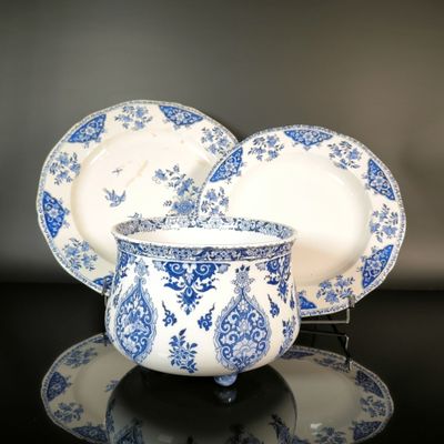 a blue and white bowl and plate set on a table