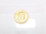 a gold coin with a picture of a man on it