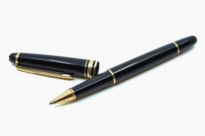 deux stylos assis l'un à côté de l'autre sur une surface blanche