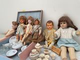 a lot of dolls that are sitting on a table