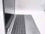 a silver laptop with a black keyboard on a white surface