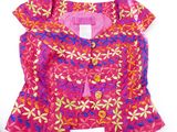 purple and pink jacket with flowers on it on a white surface