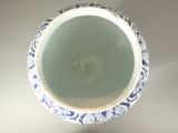 a blue and white vase sitting on a table