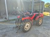 an image of a red tractor parked in front of a building