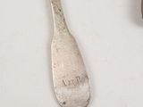 two spoons and a spoon rest on a table