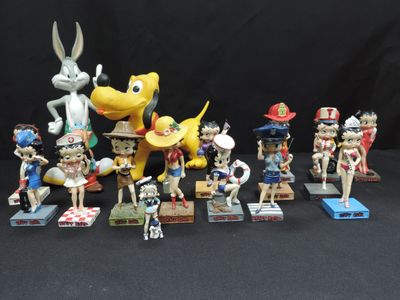 many figurines of cartoon characters on a black background