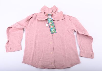 the shirt is pink and has a tie on it