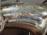 a silver saxophone that is sitting on a table