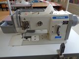 a white sewing machine sitting on a table in a room