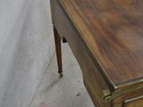 a wooden desk with a drawer on top of it