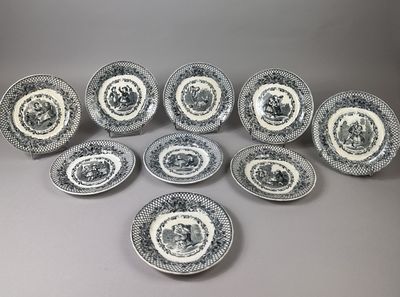 a set of twelve black and white plates with a pattern of flowers and leaves