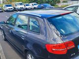 a black car parked in a parking lot next to other cars