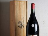 a bottle of wine sitting next to a wooden box