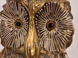 a gold owl statue sitting on top of a table