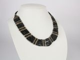 a close up of a necklace on a mannequin display
