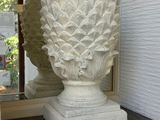 a large white vase sitting on a shelf in a room