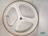 a white wheel with a red button on it
