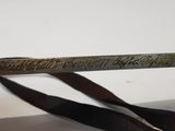 a pair of scissors with writing on them sitting on a table