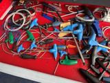 a red drawer filled with various tools and wires