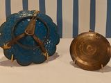 two clocks that are sitting on a table