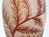 a glass vase with a tree on it on a table