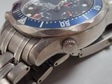 a close up of a watch on a metal bracelet
