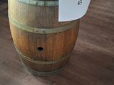 a wooden barrel with a cooler on top of it