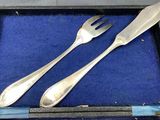 two forks and two spoons in a blue box