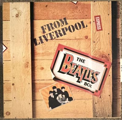 an image of a wooden box with a picture of the beatles on it