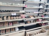 many shelves of cosmetics and makeup products in the store