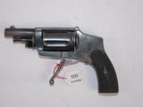 an old revolver with a tag attached to it sitting on a table