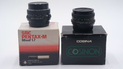 two cameras sitting next to each other on a table