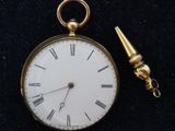 a gold pocket watch with a chain attached to it