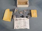 a box with a piece of paper and some other items on a table