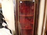 a small cabinet with a glass door in a room