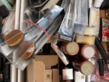 a box full of makeup brushes and other items