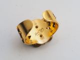 a close up of a gold ring on a white surface