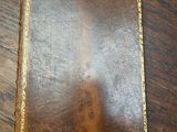 an old book sitting on top of a wooden table
