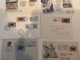 several old postcards and envelopes are displayed on a table