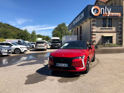 a red car is parked in front of a building with a sign that says on it