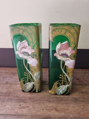 two vases that are sitting on a wooden table