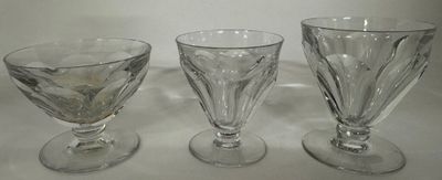 three glass goblets sitting on top of a table next to each other