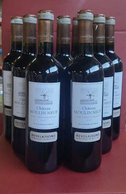 six bottles of red wine are lined up on a red table