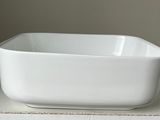 a white bowl sitting on top of a white table