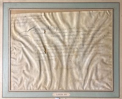 an old document with writing on it is hanging on a wall