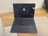 an open laptop computer sitting on top of a wooden desk