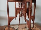 a small table with a wooden top on a wooden table