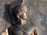 a statue of a man with a mohawk on it ' s head