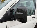an image of a side view mirror of a white van