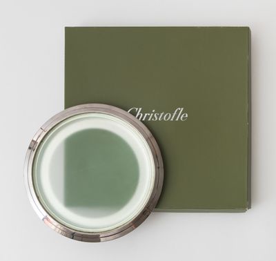 a close up of a green box with a mirror on it